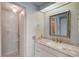 Bathroom boasts a vanity with granite countertop at 207 Dolphin N Dr, Oldsmar, FL 34677