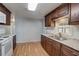 Kitchen features dark wood cabinets and granite countertops at 207 Dolphin N Dr, Oldsmar, FL 34677