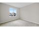 Well-lit bedroom featuring a large window and carpet at 5943 Jensen View Ave, Apollo Beach, FL 33572