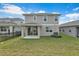 Two-story house with a covered patio and fenced yard at 5943 Jensen View Ave, Apollo Beach, FL 33572