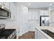 Modern kitchen with white cabinets and stainless steel appliances at 5943 Jensen View Ave, Apollo Beach, FL 33572