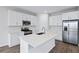 Modern kitchen with white cabinets, island, and stainless steel appliances at 5943 Jensen View Ave, Apollo Beach, FL 33572