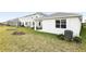 Back exterior view showing house and AC unit at 5969 Jensen View Ave, Apollo Beach, FL 33572