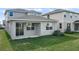Two-story home with covered patio and grassy backyard at 5917 Jensen View Ave, Apollo Beach, FL 33572