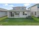 Two-story home with covered patio and grassy backyard at 5917 Jensen View Ave, Apollo Beach, FL 33572