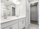 Double vanity bathroom with white cabinets and a shower at 5917 Jensen View Ave, Apollo Beach, FL 33572