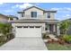 Two-story house with light beige siding and a two car garage at 5917 Jensen View Ave, Apollo Beach, FL 33572