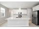 Modern kitchen with white cabinets, stainless steel appliances, and an island at 5917 Jensen View Ave, Apollo Beach, FL 33572
