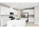 Modern kitchen with white cabinets, stainless steel appliances, and an island at 5917 Jensen View Ave, Apollo Beach, FL 33572