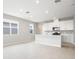Open concept kitchen with white cabinets and an island at 5917 Jensen View Ave, Apollo Beach, FL 33572