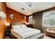 Modern bedroom featuring wood paneling, skylight, and soft, natural light at 10020 Jungle St, New Port Richey, FL 34654