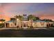 Stunning clubhouse exterior with palm trees, showcasing the beautiful architecture and landscaping at sunset at 5936 Jensen View Ave, Apollo Beach, FL 33572