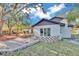 Updated home with a large backyard, stone retaining wall, and landscaping at 407 Belvedere Oval, Temple Terrace, FL 33617