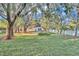 Large backyard with mature trees and lush grass at 407 Belvedere Oval, Temple Terrace, FL 33617