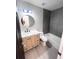 Modern bathroom with light wood vanity, gray tile, and bathtub at 407 Belvedere Oval, Temple Terrace, FL 33617