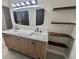 Double vanity bathroom with marble countertops and floating shelves at 407 Belvedere Oval, Temple Terrace, FL 33617