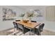 Modern dining room with a live-edge wood table and black chairs at 407 Belvedere Oval, Temple Terrace, FL 33617