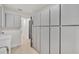 Clean hallway with light flooring and built in storage at 407 Belvedere Oval, Temple Terrace, FL 33617