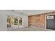 Bright living room with sliding glass doors, exposed brick wall, and hardwood floors at 407 Belvedere Oval, Temple Terrace, FL 33617
