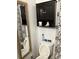 Simple bathroom with toilet, mirror, and dark wood cabinet at 109 W Floribraska Ave, Tampa, FL 33603