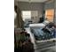 Bedroom with two twin beds and gray walls at 109 W Floribraska Ave, Tampa, FL 33603