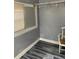Simple bedroom with gray walls and wood-look floors at 109 W Floribraska Ave, Tampa, FL 33603