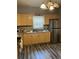 Kitchen with light wood cabinets, laminate floor, and stainless steel fridge at 109 W Floribraska Ave, Tampa, FL 33603