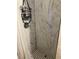 Clean shower with white marble tile and a black shower caddy at 109 W Floribraska Ave, Tampa, FL 33603