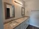 Double vanity bathroom with granite countertop and modern mirrors at 9585 Calumet Blvd, Port Charlotte, FL 33981