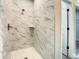 Walk in shower with marble tile and glass door at 9585 Calumet Blvd, Port Charlotte, FL 33981