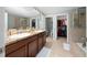 Bathroom with double sinks, shower, and walk-in closet at 8609 Fiddleleaf Ct, Tampa, FL 33647