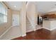 Bright entryway with staircase and view into kitchen at 8609 Fiddleleaf Ct, Tampa, FL 33647