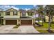 Two-story townhome with double garage and landscaped yard at 8609 Fiddleleaf Ct, Tampa, FL 33647