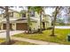Two-story townhome with brown garage doors and a well-manicured lawn at 8609 Fiddleleaf Ct, Tampa, FL 33647