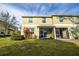 Two story townhome with a screened porch and landscaped yard at 8609 Fiddleleaf Ct, Tampa, FL 33647