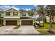 Front view of a two-story townhome with double garage at 8609 Fiddleleaf Ct, Tampa, FL 33647