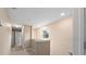 Upstairs hallway with carpet and neutral walls at 8609 Fiddleleaf Ct, Tampa, FL 33647
