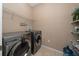 Laundry room with washer, dryer and shelving at 8609 Fiddleleaf Ct, Tampa, FL 33647