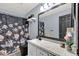 Clean bathroom with floral shower curtain, modern vanity, and large mirror at 1313 Louisiana St, Plant City, FL 33563