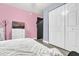 Bright bedroom with pink walls, double bed, and spacious closet at 1313 Louisiana St, Plant City, FL 33563