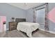 Cozy bedroom with gray walls, double bed, and wood nightstand at 1313 Louisiana St, Plant City, FL 33563