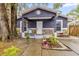Cute gray house with stone accents, covered porch, and well-manicured landscaping at 1313 Louisiana St, Plant City, FL 33563