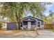 Charming gray house with stone accents and a spacious front yard at 1313 Louisiana St, Plant City, FL 33563
