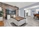 Open living room with stone accent wall, large TV, and comfy seating at 1313 Louisiana St, Plant City, FL 33563