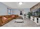 Spacious living room with L-shaped couch, stone accent wall, and a large TV at 1313 Louisiana St, Plant City, FL 33563