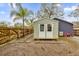 Light green storage shed with double doors in the backyard at 1313 Louisiana St, Plant City, FL 33563