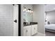 Bathroom with double vanity, a large mirror, and a shower at 9049 Players Dr, Weeki Wachee, FL 34613