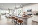 Open concept kitchen island with white cabinets, stainless steel appliances, and spacious layout at 9049 Players Dr, Weeki Wachee, FL 34613