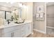 Double vanity bathroom with white cabinets and gray countertops at 9093 Players Dr, Weeki Wachee, FL 34613