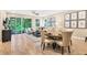 Open floor plan with dining and living areas, featuring hardwood floors and sliding doors to patio at 9093 Players Dr, Weeki Wachee, FL 34613